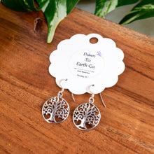 Load image into Gallery viewer, "Silver tree-shaped earrings on a wooden surface with a branded card," - Down to Earth.
