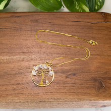 Load image into Gallery viewer, Tree of Life Rose Quartz Gold Necklace top down on a stand on a style background - Down To Earth
