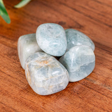 Load image into Gallery viewer, Aquamarine Tumbled on a wooden surface high angle - Down to Earth 
