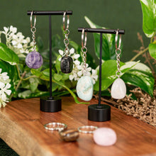 Load image into Gallery viewer, Tumbled Crystal Keychains displayed on a colorful background - Down to Earth

