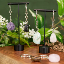 Load image into Gallery viewer, Tumbled Crystal Keychains displayed on a colorful background second angle - Down to Earth
