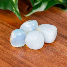 Load image into Gallery viewer, Opalite Tumbled on a wooden surface high angle - Down to Earth 
