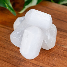 Load image into Gallery viewer, Selenite Tumbled on a wooden surface high angle - Down to Earth 
