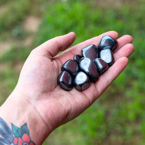 Tumbled Hematite in Palm of a Hand - Down To Earth