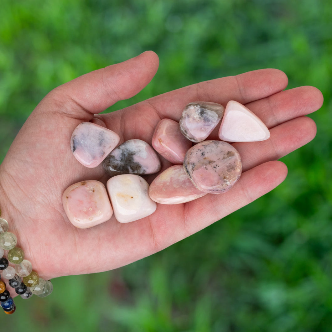 Tumbled Pink Opal in the palm of a hand - Down To Earth