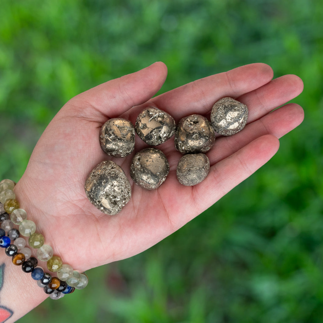 Tumbled Pyrite in the palm of a Hand - Down To Earth