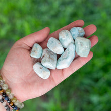 Load image into Gallery viewer, Tumbled Larimar in the palm of a hand - Down To Earth
