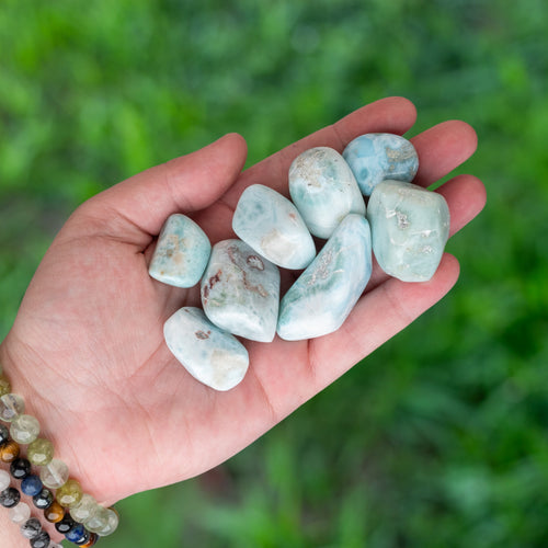 Tumbled Larimar in the palm of a hand - Down To Earth