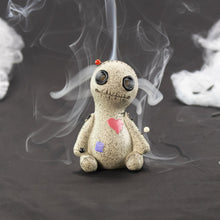 Load image into Gallery viewer, Voodoo Doll Incense Burner with the incense cone on displayed on a styled background - Down To Earth
