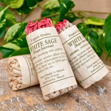 Load image into Gallery viewer, &quot;White Sage rope incense with packaging on a wooden surface with green leaves in the background,&quot; - Down to Earth.
