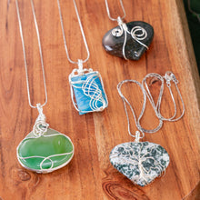 Load image into Gallery viewer, Wire Wrapped Crystal Necklace group on a wooden surface - Down to Earth
