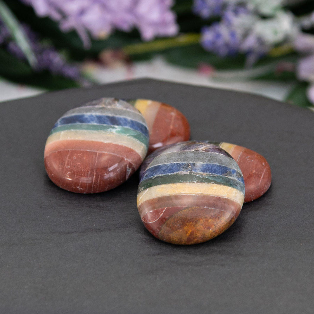Chakra Worry Stone in a styled photo - Down to Earth 