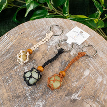 Load image into Gallery viewer, "Three Adjustable Crystal Keychains in the color variations beige, black, and brown," - Down to Earth.
