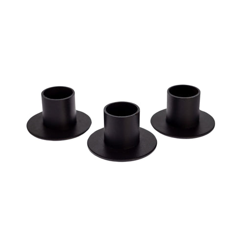 Photo of three black metal candle holders staggered. - Down to Earth.