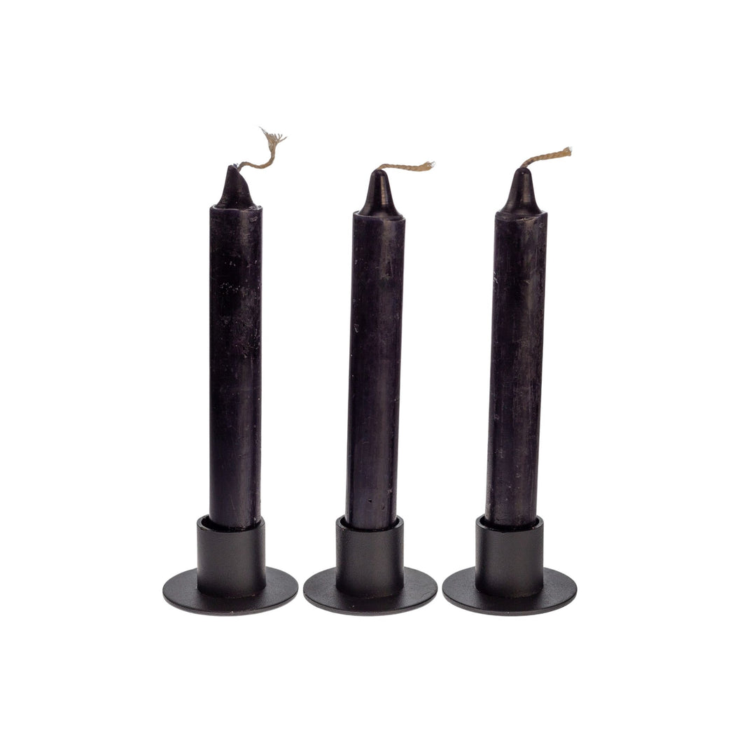 Photograph of three black ritual candles. These candles are sold by Down to Earth based out of Wichita, Kansas. - Down to Earth.