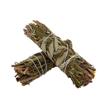 Load image into Gallery viewer, "Two bundles of black sage, also known as mugwort, wrapped in white twine on a white background," - Down to Earth.
