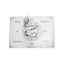 Load image into Gallery viewer, Top down view of a moonstone pendulum with 7 chakra stones on the chain. This pendulum also comes with a card to assist in divination. - Down To Earth.
