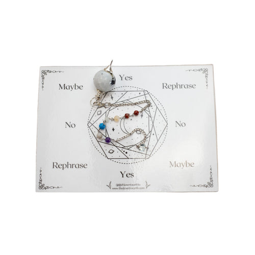 Top down view of a moonstone pendulum with 7 chakra stones on the chain. This pendulum also comes with a card to assist in divination. - Down To Earth.