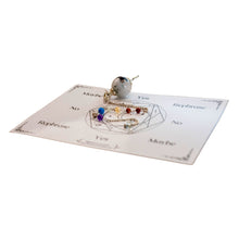 Load image into Gallery viewer, Photo of a moonstone pendulum resting on a divination card. - Down to Earth.
