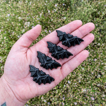 Load image into Gallery viewer, &quot;Open palm with four crystal-shaped bats with greenery in the background,&quot; -  Up N Smoke.
