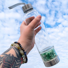 Load image into Gallery viewer, &quot;Clear water bottle with a separate base chamber filled with Green Aventurine crystal chips,&quot; - Down to Earth.
