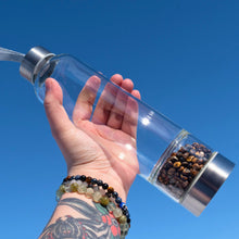 Load image into Gallery viewer, &quot;Clear glass water bottle with Tiger&#39;s Eye crystal chips in the bottom chamber,&quot; - Down to Earth.
