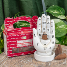 Load image into Gallery viewer, &quot;Dragon&#39;s Blood Backflow Dhoop Cones next to a Palmistry Backflow Burner on a wooden plank with foliage in the background,&quot; - Down to Earth.
