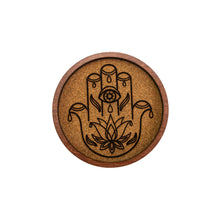 Load image into Gallery viewer, "Wooden coaster with Hamsa hand design on a white background," - Down to Earth.
