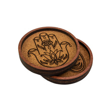 Load image into Gallery viewer, "Side angle of two wooden metaphysical coasters with a hamsa hand and planchette design on a white background," - Down to Earth.
