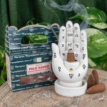 Load image into Gallery viewer, &quot;Palo Santo Backflow Incense Cones next to a Palmistry Incense Burner on a wooden plank with green foliage in the background,&quot; - Down to Earth.

