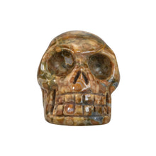 Load image into Gallery viewer, &quot;Face-on view of a rhyolite carved skull against a white background,&quot; - Down to Earth.

