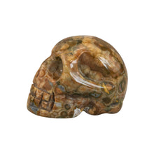 Load image into Gallery viewer, &quot;Complete left side of a carved rhyolite crystal skull against a white background,&quot; - Down to Earth.
