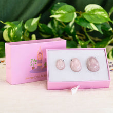 Load image into Gallery viewer, &quot;An open light pink box propped up against its lid, showcasing three rose quartz yoni eggs,&quot; - Down to Earth.
