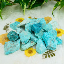 Load image into Gallery viewer, &quot;Pile of rough turquoise surrounded by greenery and yellow flowers,&quot; - Down to Earth.

