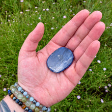 Load image into Gallery viewer, &quot;Open hand with a Sodalite palm stone in the center and greenery in the background,&quot; - Down to Earth.
