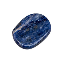 Load image into Gallery viewer, &quot;Sodalite, a blue crystal with white swirling streaks, in a palm stone shape against a white background,&quot; - Down to Earth.
