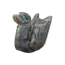 Load image into Gallery viewer, &quot;Carved stone duck figure with a blue eye on a white background,&quot; - Down to Earth.
