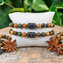 Load image into Gallery viewer, "Pisces Zodiac Bracelets on a white pillow with star anise in front with green foliage in the background," - Down to Earth.
