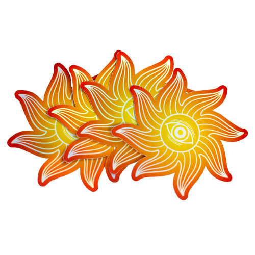 Picture of a group of sunburst eye stickers. These orange and red stickers are holographic and have a rainbow shimmer when the light hits them. - Down to Earth.