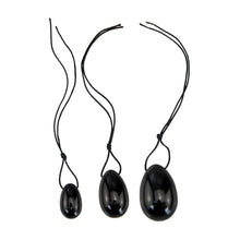 Load image into Gallery viewer, &quot;Three black obsidian yoni eggs in small, medium, and large,&quot; - Down to Earth.
