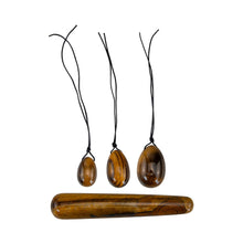Load image into Gallery viewer, &quot;Three tiger&#39;s eye yoni eggs with a crystal wand. These items are used in Kegel exercises to strengthen the pelvic floor,&quot; - Down to Earth.
