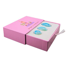 Load image into Gallery viewer, &quot;Left-side view of an opalite yoni egg set within a light pink box,&quot; - Down to Earth.
